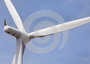 Close up wind turbine alternative energy with blue sky background