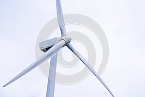 Close up of Wind turbine generating electricity clean energy with cloud background on the sky. Clean energy concept.