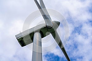 Close up of Wind turbine generating electricity clean energy with cloud background on the sky. Clean energy concept.