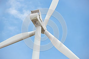 Close-up wind turbine in rotation to generate electricity energy on outdoor with  blue sky background, Conservation and
