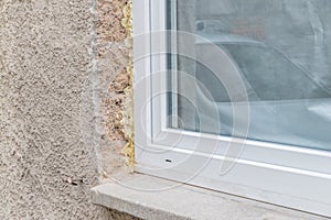 Close-up of a window in the shell with construction foam and window sill, Germany