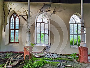 CLOSE UP: Windows are broken and facade decays inside an abandoned church.