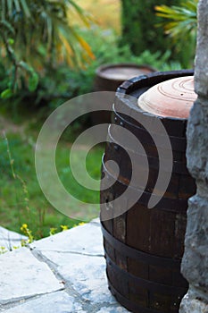 Close up of a wine cask at the winery garden. Wine barrel outside of wine cellar in the garden of a picturesque vineyard