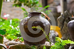 Close-up of wine jars placed outdoors in rural China