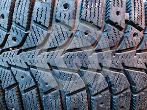 Close-up of winter studded car tyre protector photo