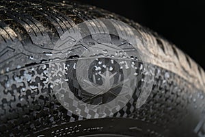 Close-Up of Winter Tire with Snowflake Symbol and Tread Pattern photo