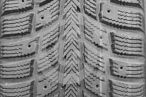Close-up winter tire tread. Textured tire tread. Part of brand new modern winter car tire