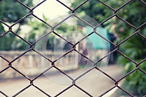 Close-up wire mesh fence with rust