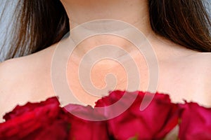 close up woman 50 years old, female neck in flowers, small wrinkles on skin, concept of beauty and cosmetic anti-aging procedures