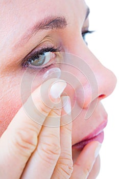 Close up of woman applying contact lens