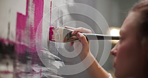 Close Up of Woman Artist Hand, Holding Paint Brush and Drawing Oil Painting.