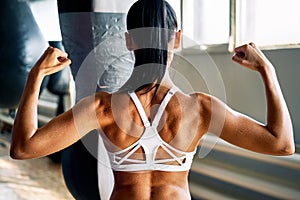 Close up of woman back with flexing her muscles