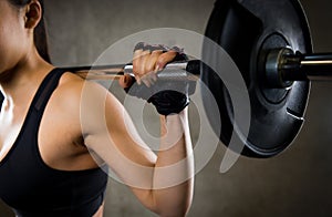 Close up of woman with barbell in gym
