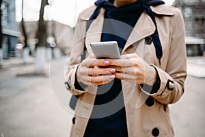 Close-up of a woman in a beige coat