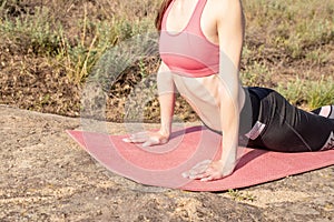 Close up of woman body stretching to the sun,practicing yoga upward facing dog pose