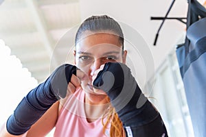 close-up of a woman in boxing pose looking at the camera