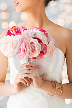 Close up of woman or bride with flower bouquet