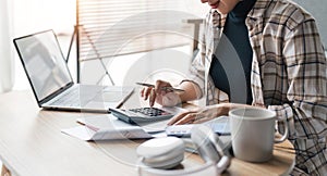 Close up of woman busy paying bills online on computer calculating household finances or taxes on machine, female manage