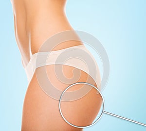 Close up of woman buttocks and magnifier