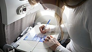 CLOSE UP: Woman carefully reading immigration papers before filling them out.