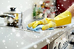 Close up of woman cleaning cooker at home kitchen