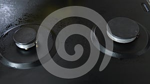 Close up of woman cleaning gas stove at home kitchen. Cleaning and tidying the household gas stove