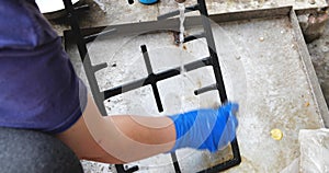 Close up of woman cleaning kitchen stove