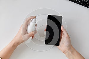 Close up of woman cleaning smartphone photo