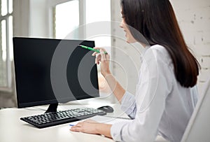 Close up of woman with computer monitor in office