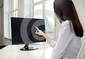 Close up of woman with computer monitor in office
