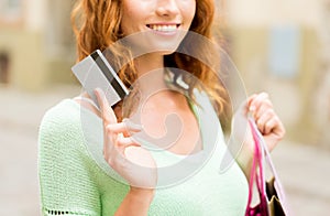 Close up of woman with credit card and bag