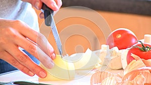 Close up of a woman cutting onions