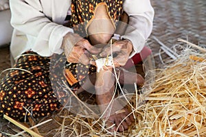 Close up of a woman doing basketwork, wickerwork