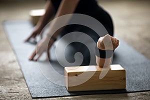 Close up of woman doing splits with block for deep stretch