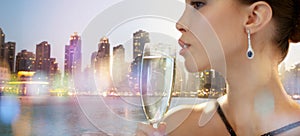 Close up of woman drinking champagne in night city