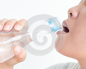 Close up woman drinking water from bottle on white background