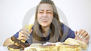 Close-up woman eating cupcakes with frenzy after debilitating diet