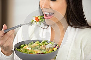 close up woman eating salad