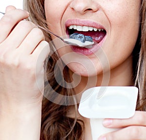 Close-up of a woman eating a yogurt