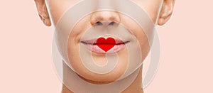 Close up of woman face with heart shape on lips