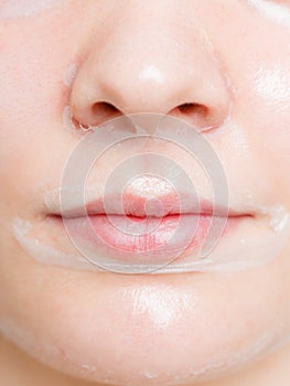 Close up woman in facial peel off mask.