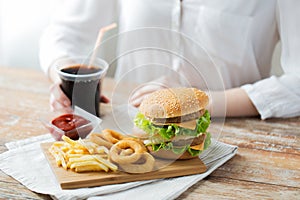 Close up of woman with fast food and cocacola