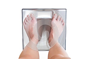 close-up of woman feet weighing scale isolated on white background.