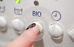 Close up of woman finger pressing washer button