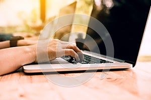 Close up woman finger typing on keyboard laptop.