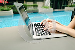 close up woman fingers pressing keyboard on laptop sunny day swi