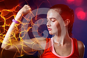 Close-up of woman flexing muscles in gym