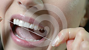 Close Up Of Woman Flossing White Teeth