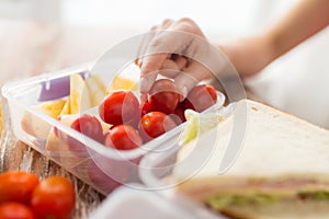 Close up of woman with food in plastic container