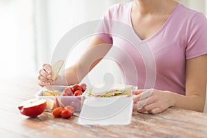 Close up of woman with food in plastic container